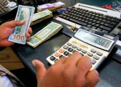 مكتب لموظف في السودان يحمل دولار ويعادل قيمته من خلال الحاسبة